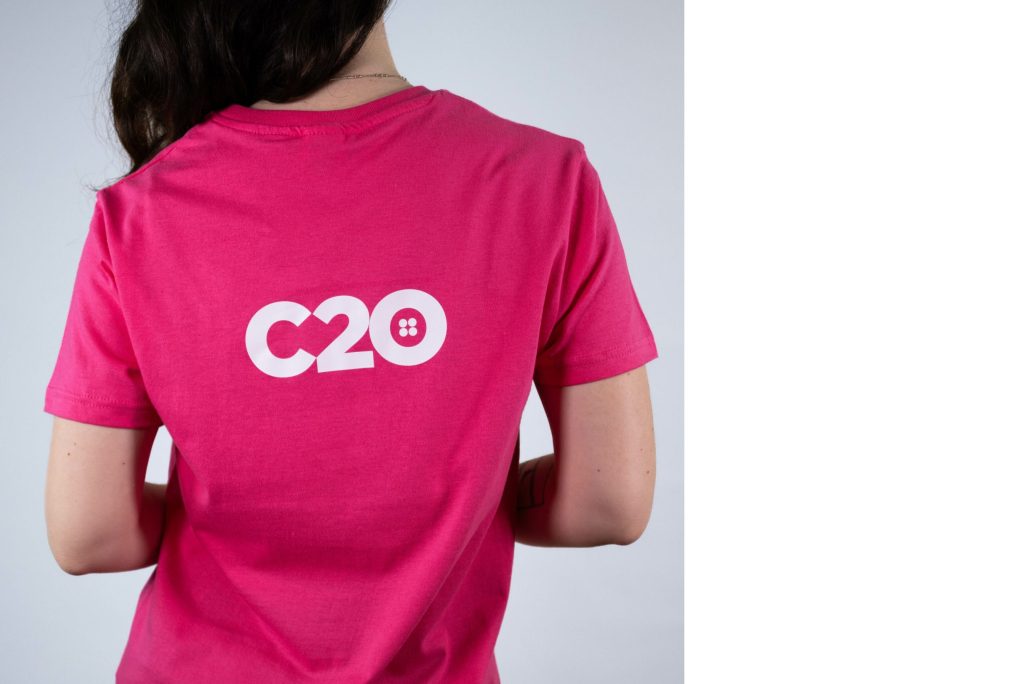 Pink t-shirt featuring Shoulder Blades logo placement.