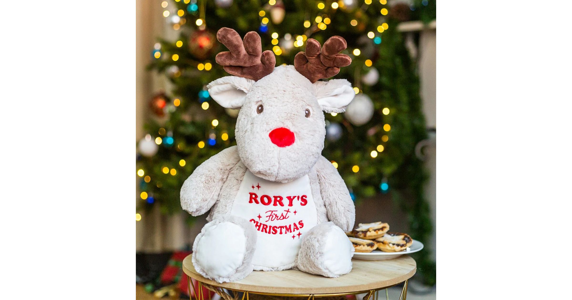 embroidery on a stuffed reindeer saying Rory's first Christmas in red text