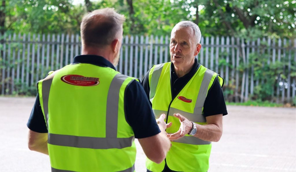 2 men with custom branded hi-vis vests